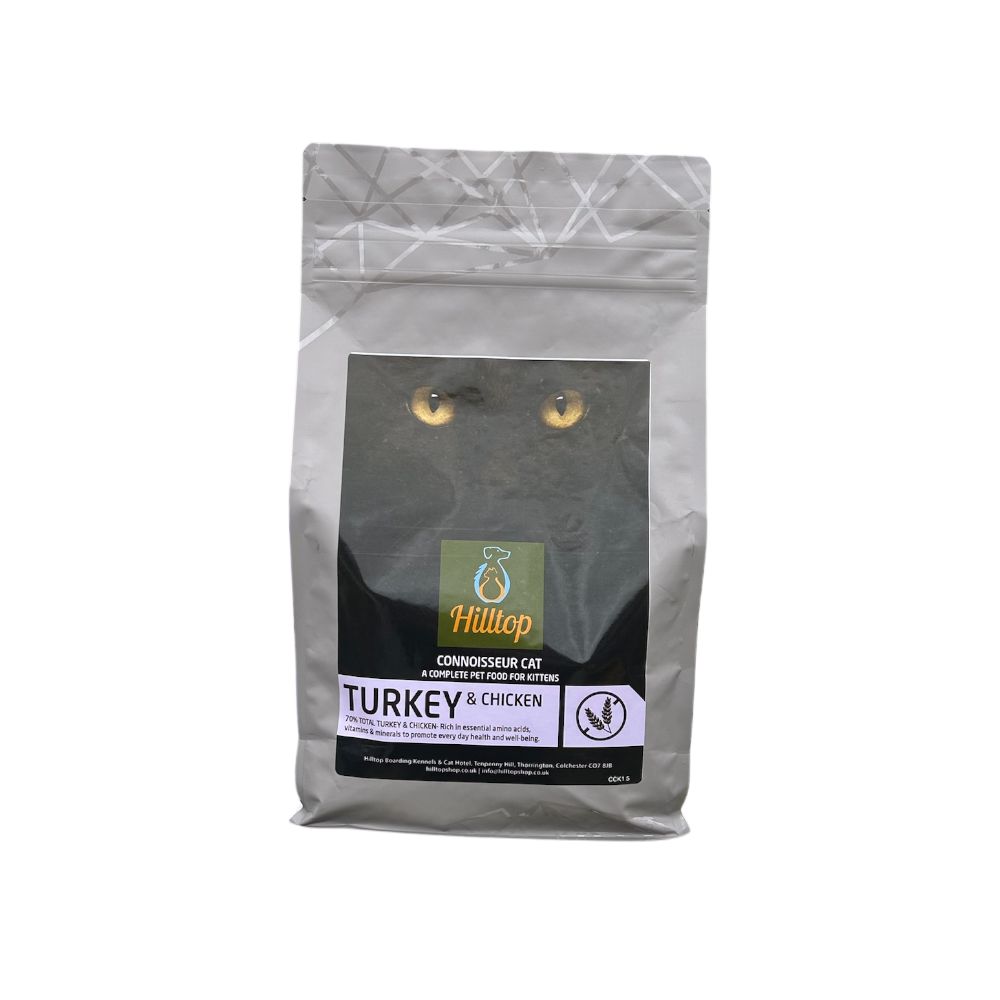 A silver bag of Hilltop Pet Food Connoisseur Kitten Cat Food—Turkey & Chicken—with a cat face on the packaging.