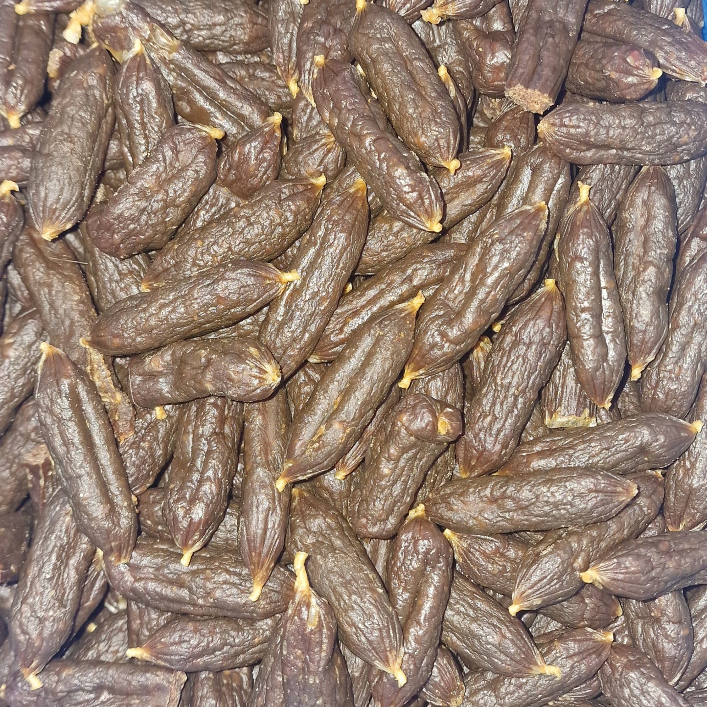 closeup of a pile of chicken mini sausage dog treats