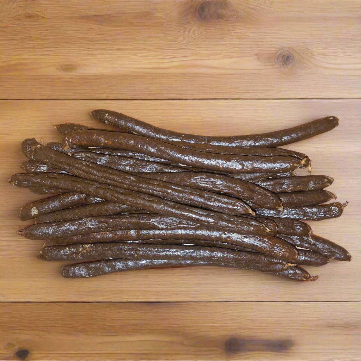 long pork sausages on wooden surface