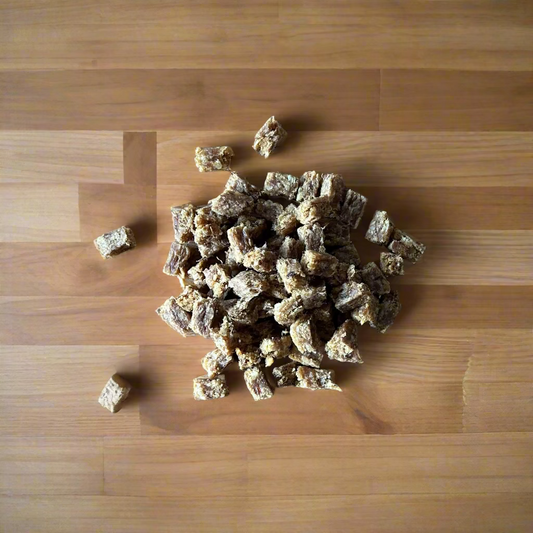 small pile of 100% meat training cubes on a wooden worktop