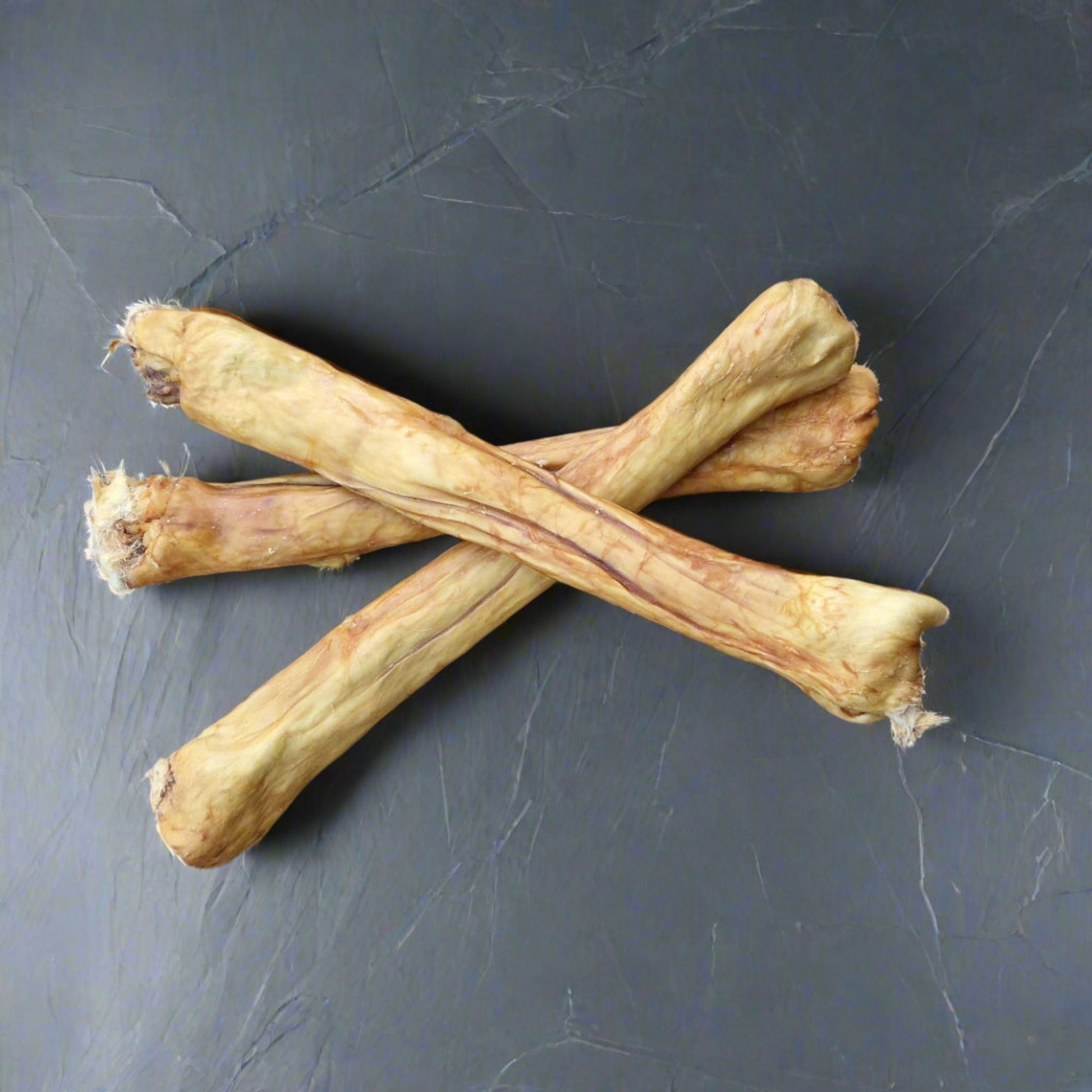 3 rabbit pelts on a slate worktop
