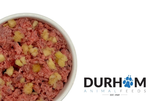 A bowl of Hilltop Pet Food’s Durham: Chicken & Apple Complete Mince 454g sits by the Durham Animal Feeds logo.