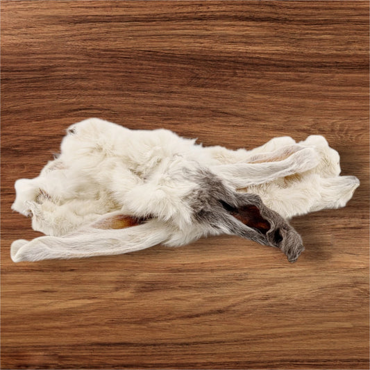 Hilltop Pet Food’s Furry Rabbit Ears, in white and gray, rest subtly on a wooden surface.
