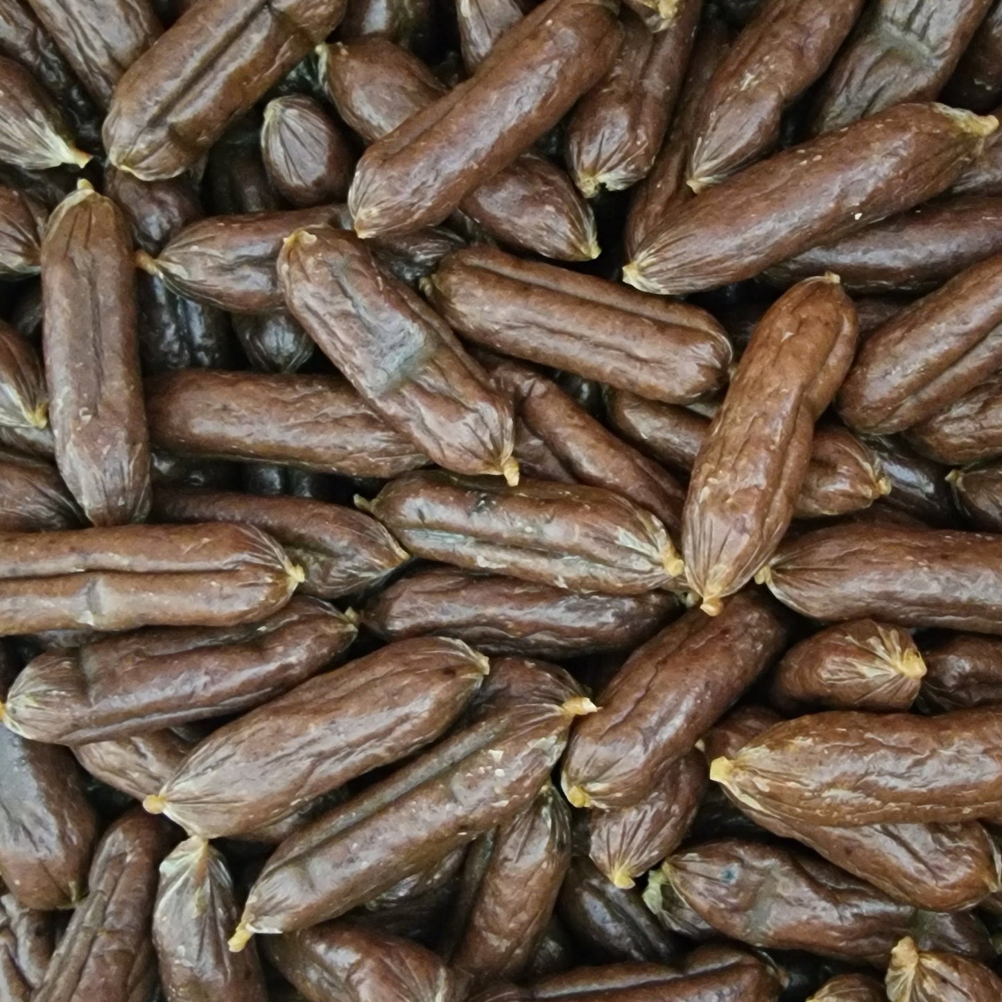 Closeup of meaty mini sausages lamb & chicken