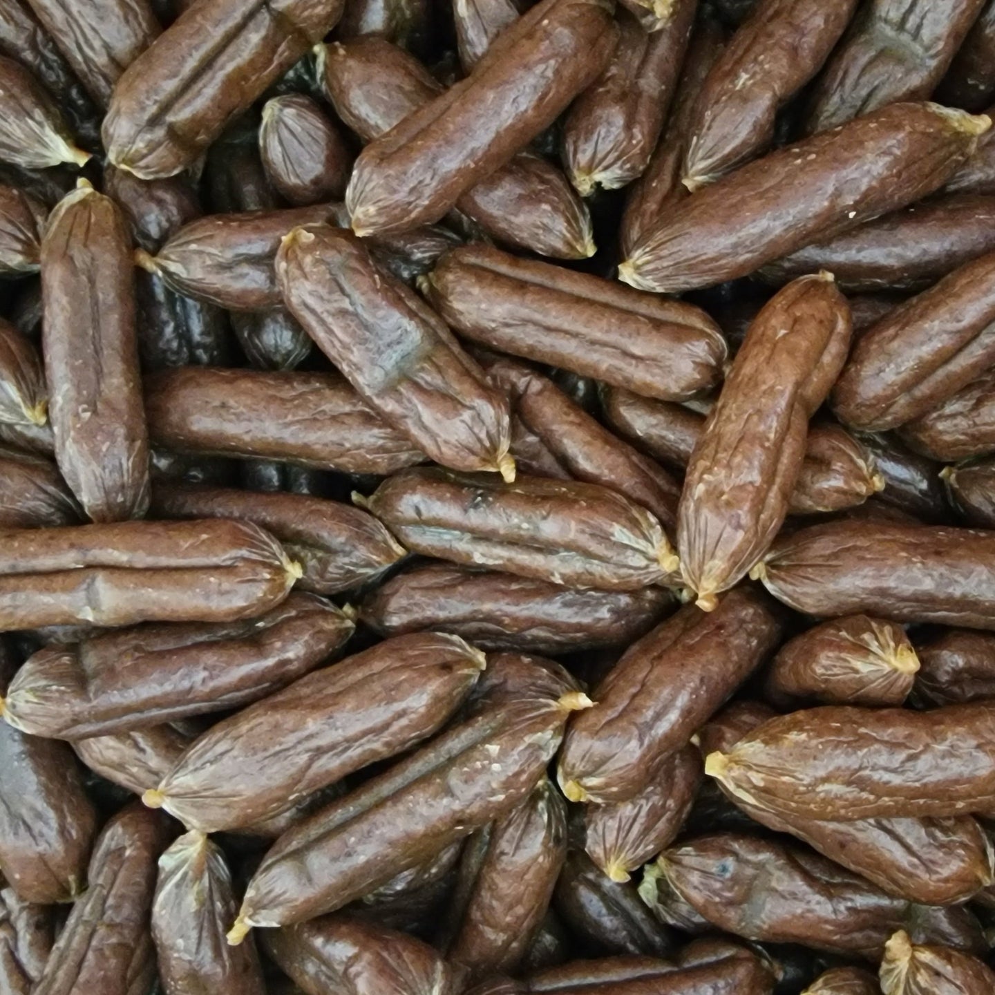 Closeup of meaty mini sausages lamb & chicken