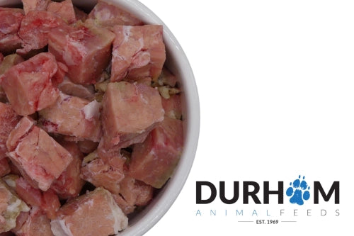 Pig pancreas chunks served in a raw dog food bowl – natural supplement for healthy digestion and EPI support. With Durham logo.