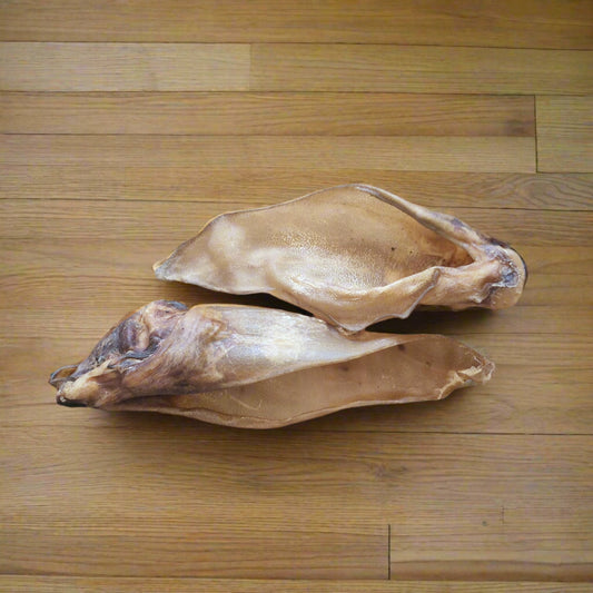 Two buffalo ears on a wooden surface