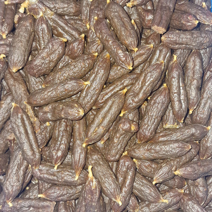 closeup of a pile of chicken mini sausage dog treats