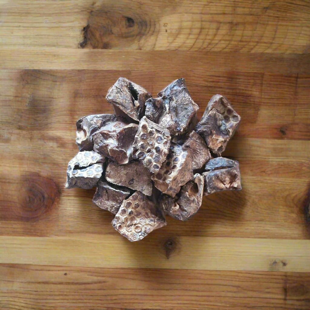 puffed beef lung cubes arranged on a wooden worktop