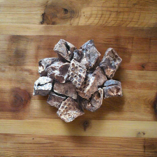 puffed beef lung cubes arranged on a wooden worktop